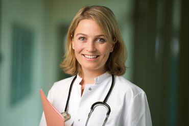 Female doctor with stethoscope smiling