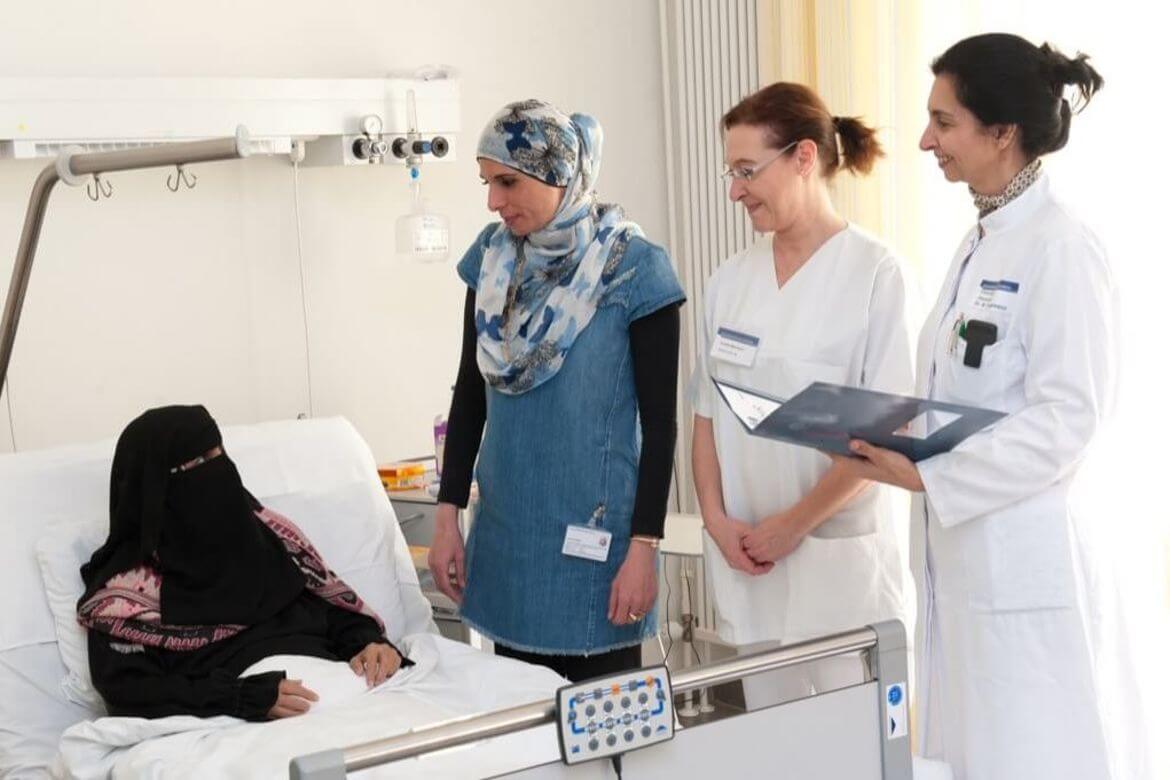 Arabic_female_patient_in_bed_with_translator_and_doctor