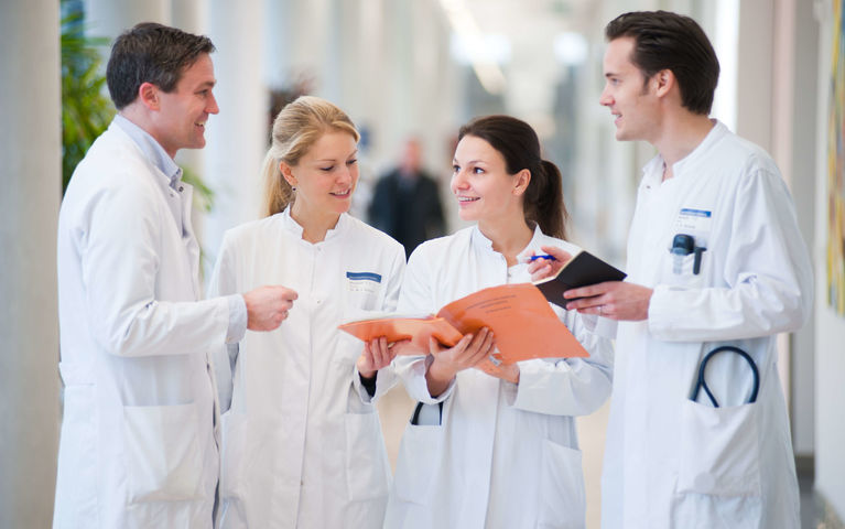 Four physicians discussing in Hallway at Heidelberg University Hospital