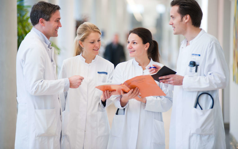 Four physicians discussing in Hallway at Heidelberg University Hospital