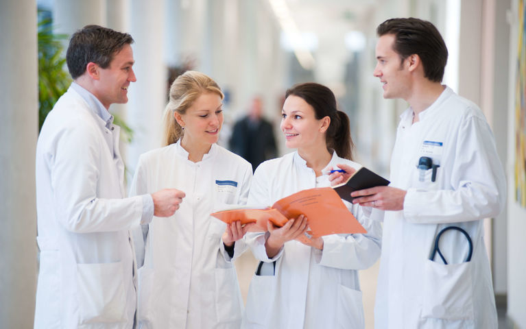 Four physicians discussing in Hallway at Heidelberg University Hospital