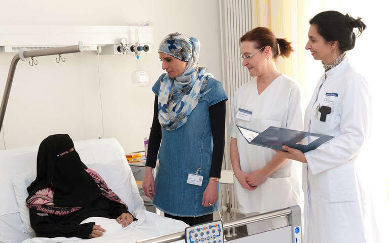 Translator and doctor on patient bed