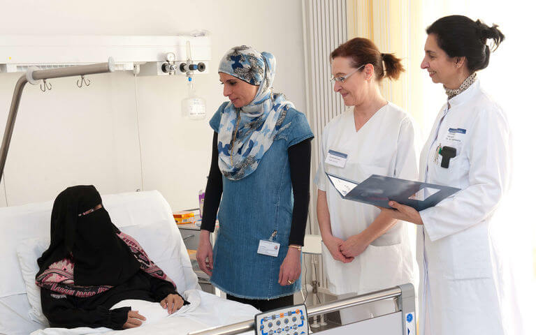 Translator and doctor on patient bed